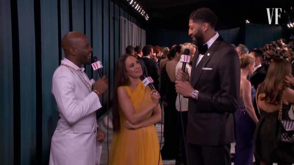 Karamo Brown and Catt Sadler speaking with a basketball player