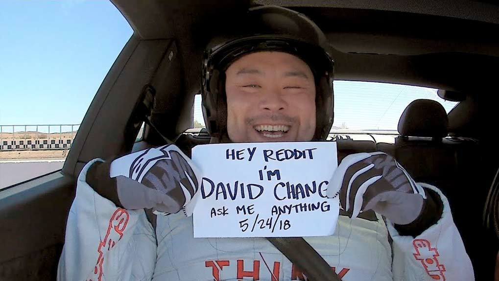David Chang in car holding Ask Me Anything sign
