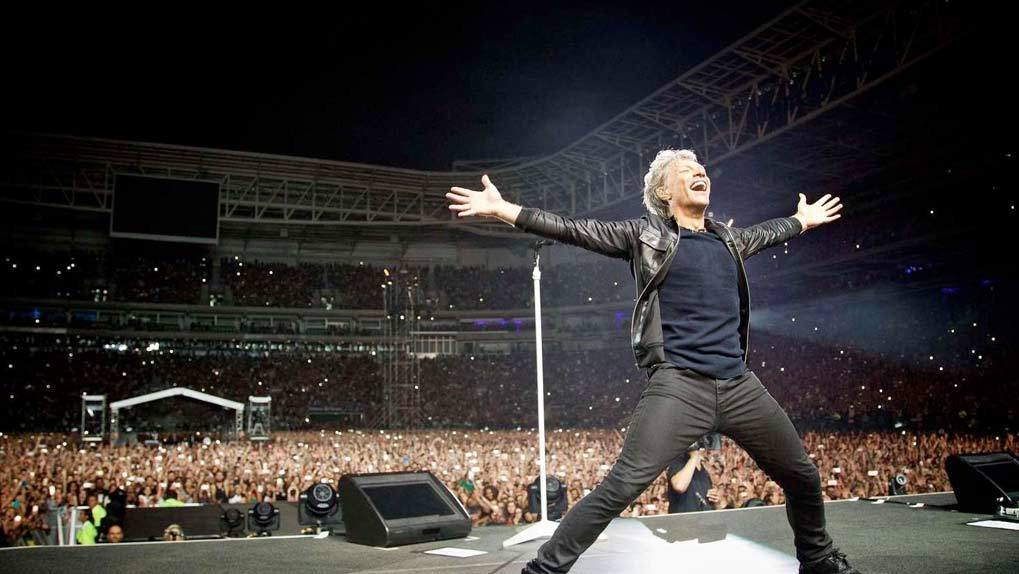 Bon Jovi performing in front of huge stadium crowd