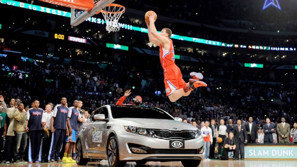 NBA player slam dunking over KIA on basketball court