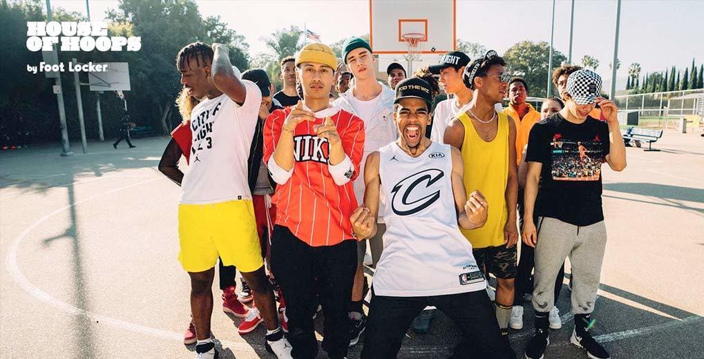 Group of individuals on basketball court posing and acting excited with hip and stylish clothing