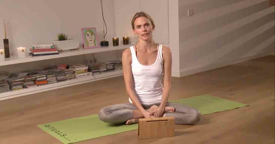 Actress sitting on yoga mat