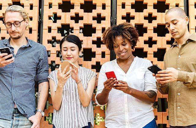 Group of diverse people looking at their phones